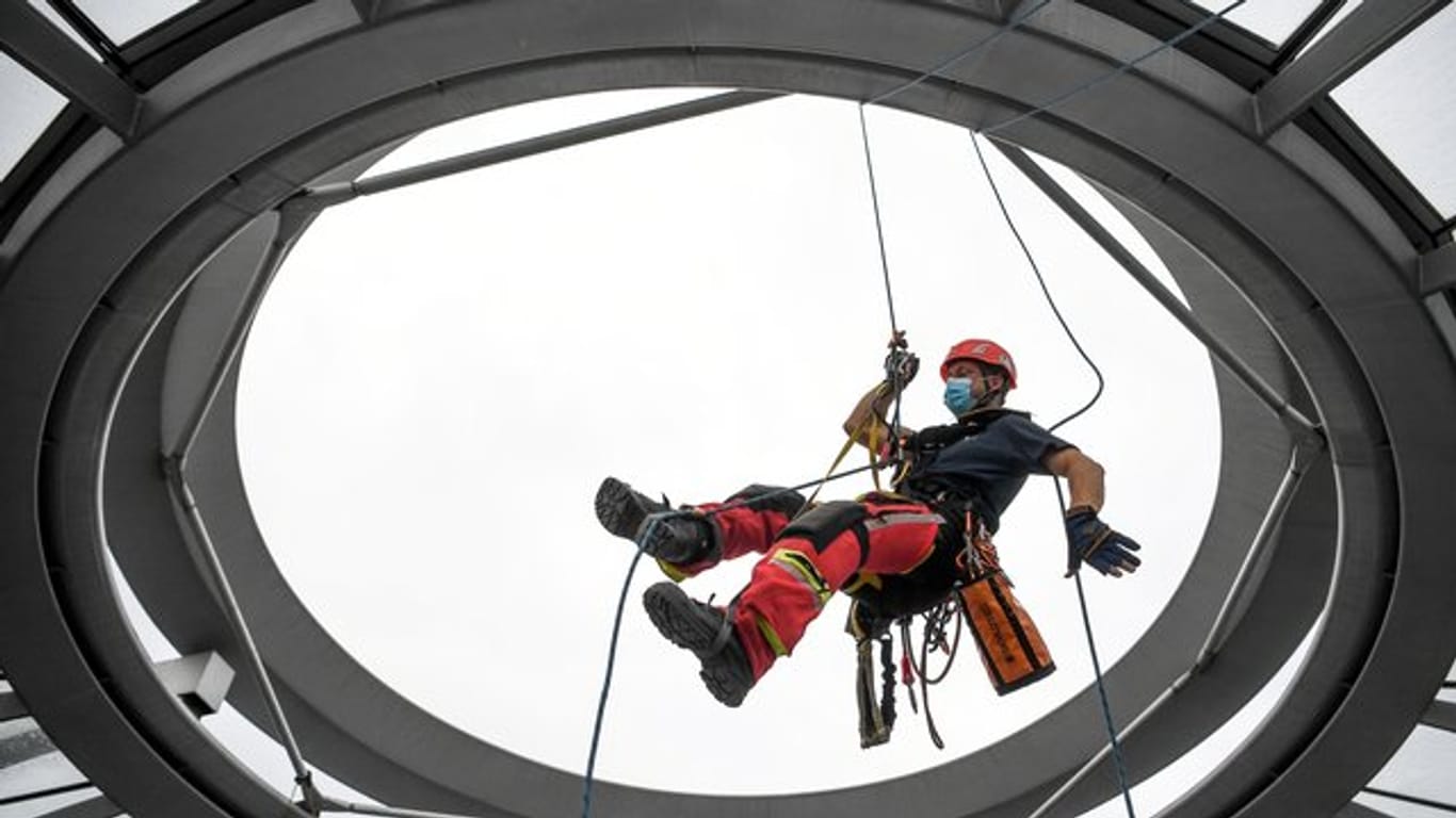 Ein Höhenretter der Feuerwehr: Bei einer Übung zur Bergung eines Verletzten seilt er sich in das Innere der Reichstagskuppel ab.