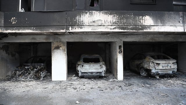 Ausgebrannte Fahrzeuge stehen in der Garage eines Mietshauses in Berlin-Neukölln: Ein Wohnhaus musste infolge des Brandes geräumt werden. Ausgebrannte Fahrzeuge stehen in der Garage eines Mietshauses in Berlin-Neukölln: Ein Wohnhaus musste infolge des Brandes geräumt werden.