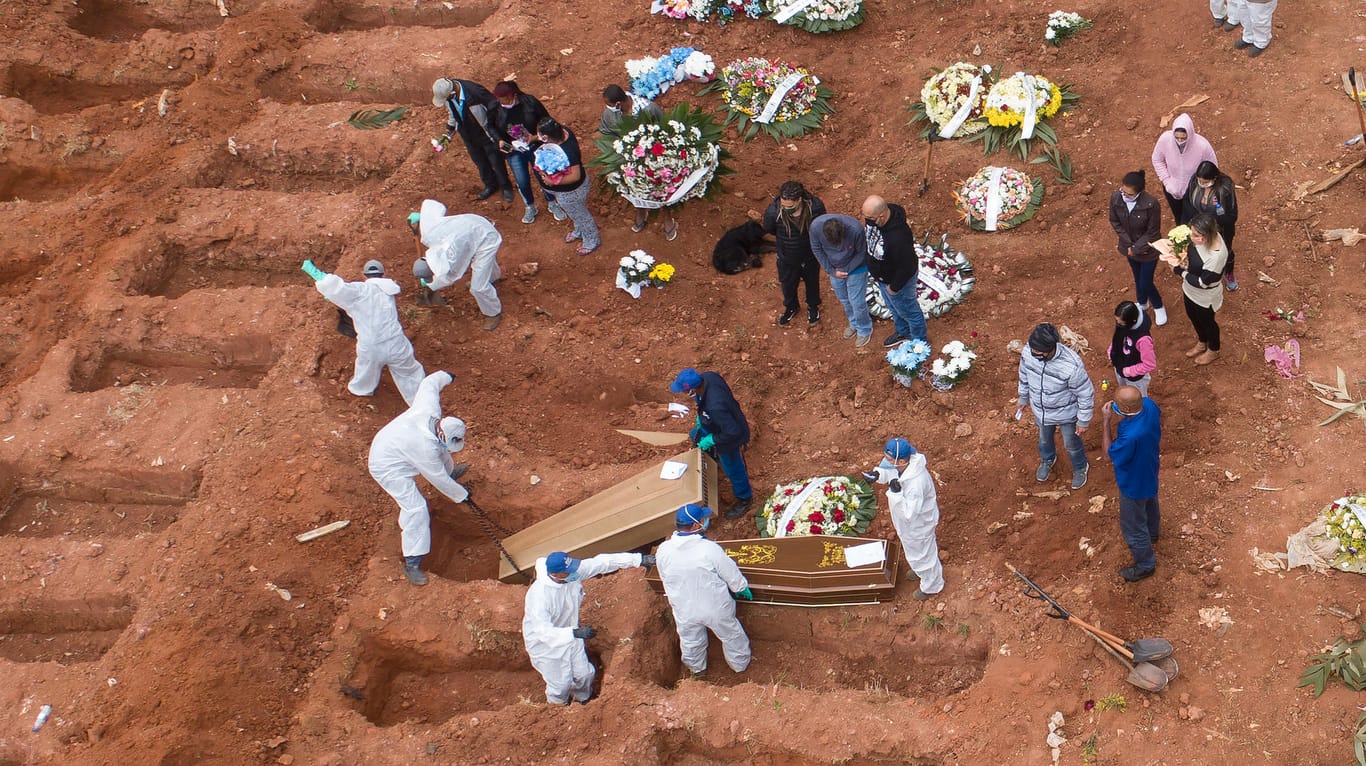 Friedhofsmitarbeiter in Schutzkleidung begraben ein Opfer von Covid-19: In Brasilien steigen die Opferzahlen weiter an.