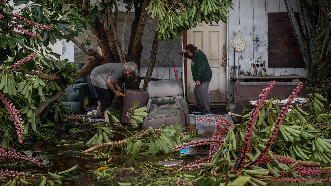 Couple clear debris from destroyed home in aftermath of Hurricane Hanna in Port Mansfield, Texas