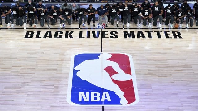 Alle Spieler der New Orleans Pelicans und von Utah Jazz knien vor einem "Black Lives Matter"-Schriftzug. Alle Spieler der New Orleans Pelicans und von Utah Jazz knien vor einem "Black Lives Matter"-Schriftzug.