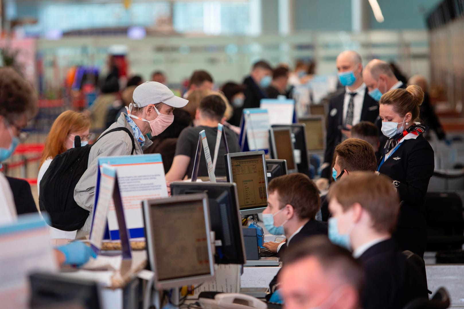 Corona-Virus in Russland: Ein Passagier mit Gesichtsmaske steht vor einem Abfertigungsschalter am Internationalen Flughafen Scheremetjewo