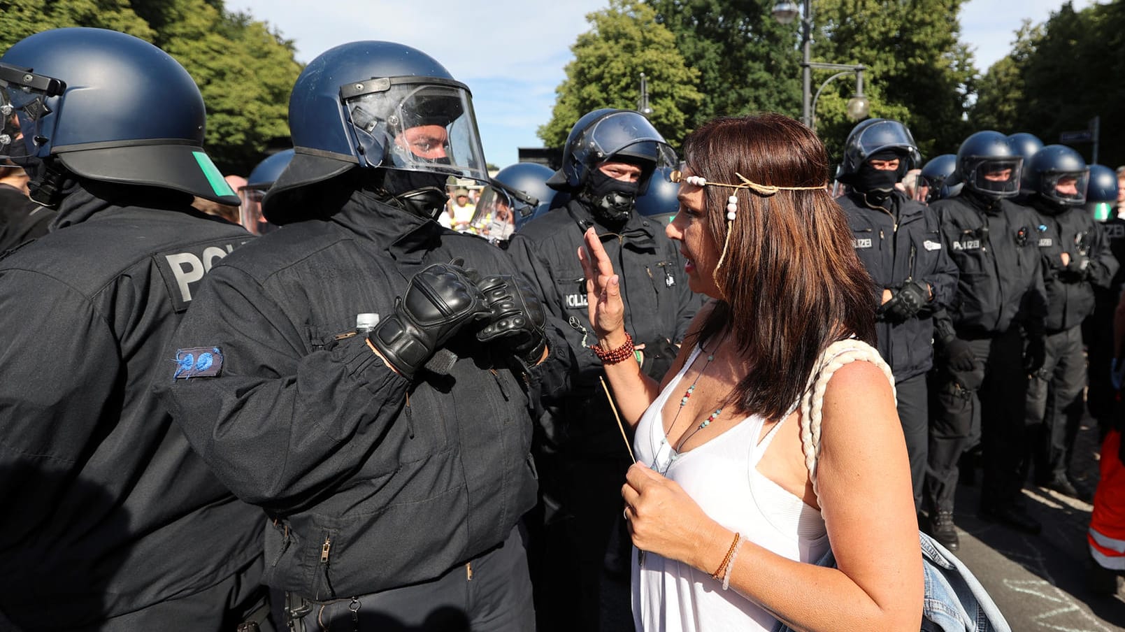 Eine Teilnehmerin der Corona-Demo in Berlin diskutiert mit einem Polizisten: Bei den Protesten wurden die Abstandsregeln nicht eingehalten.