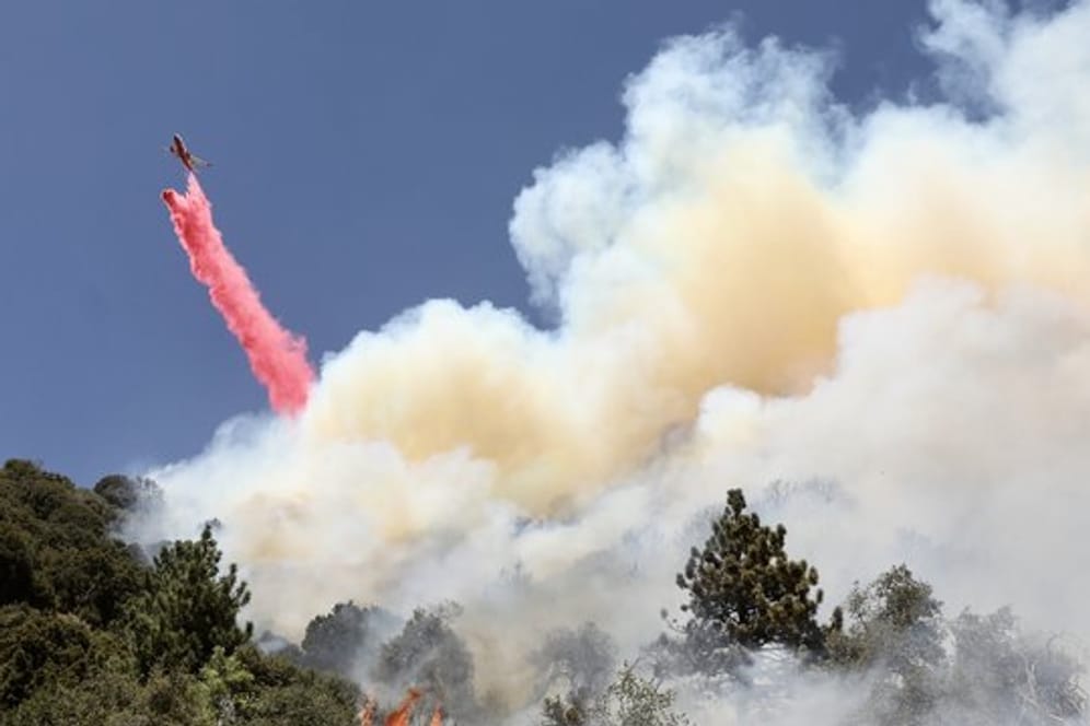 Feuerwehrleute kämpfen mit Unterstützung von Löschflugzeugen gegen den Waldbrand im Bezirk Riverside County.