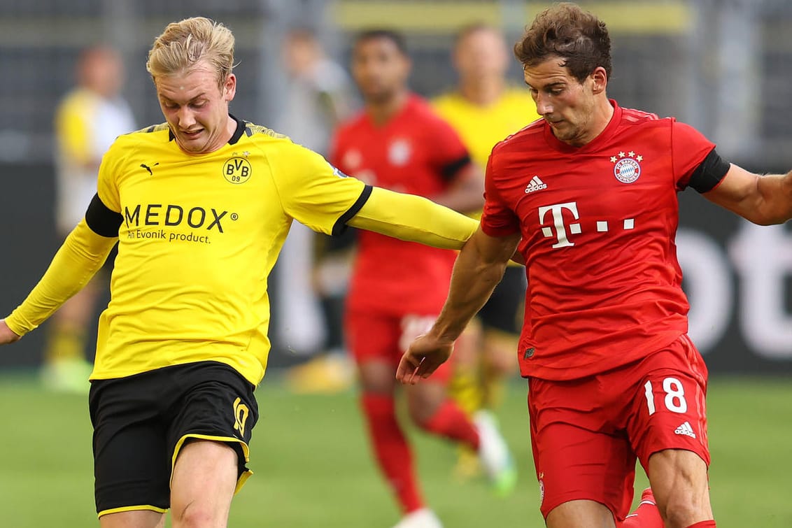 Bundesliga: Sehen die Zuschauer einen Zweikampf wie diesen zwischen Dortmunds Julian Brandt und Münchens Leon Goretzka bald wieder im Stadion?