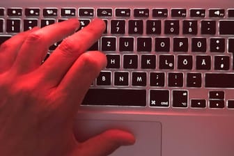 Eine Hand an einer Tastatur (Symbolbild): Wer strafbare Inhalte im Netz findet, kann diese der Polizei melden.