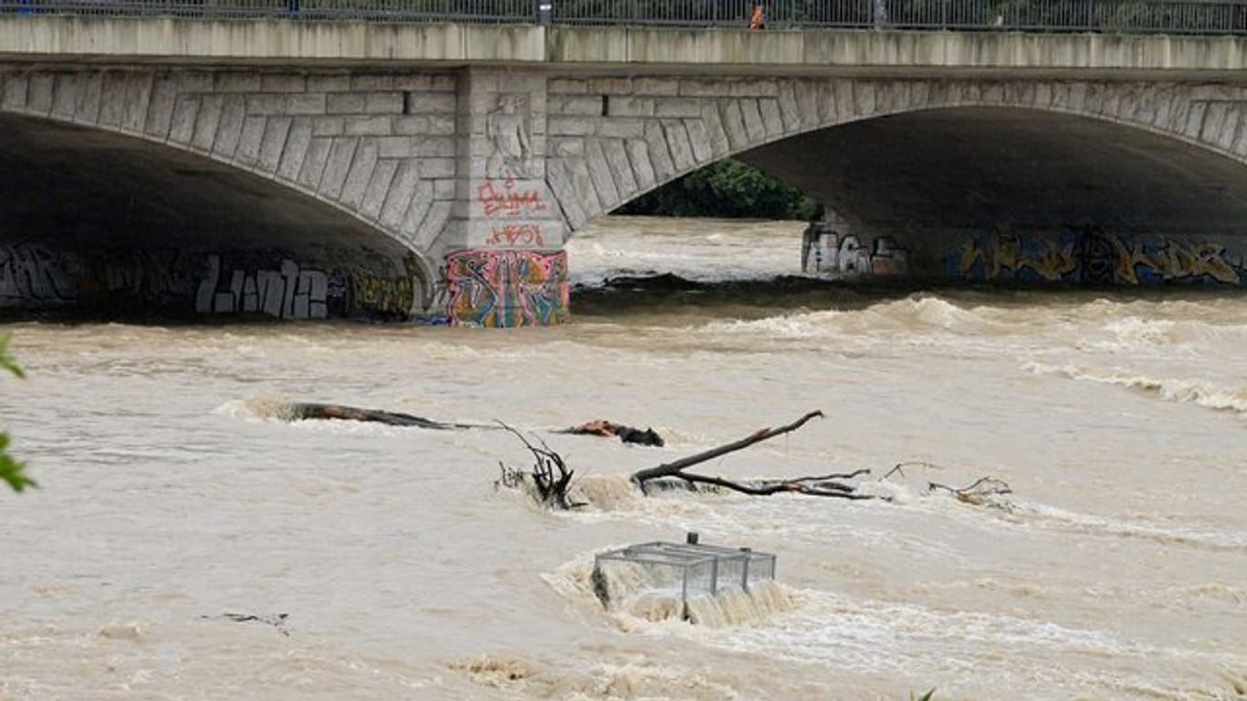 Nach starkem Regen fließt braunes Wasser unter der Reichenbachbrücke durch das Flussbett der Isar in München.