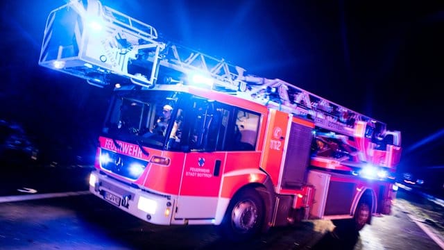 Ein Fahrzeug der Feuerwehr ist mit Blaulicht im Einsatz Ein Fahrzeug der Feuerwehr ist mit Blaulicht im Einsatz