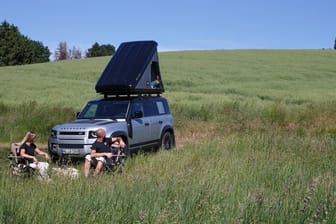 Das Zelt beim Land Rover Defender wird per Kurbel aus einer auf der Reling montierten Transportkiste geleiert.
