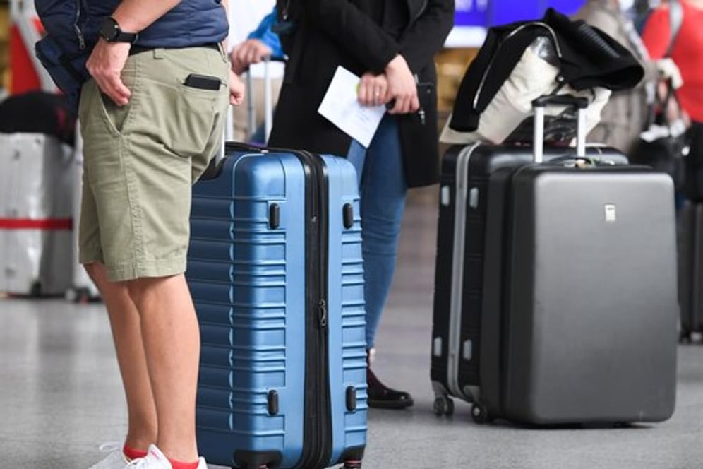 Flugreisende am Check-in-Schalter eines Flughafens.
