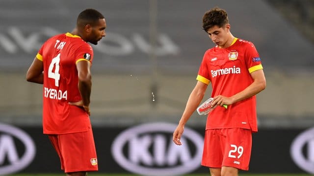 Leverkusens Jonathan Tah (l) und Kai Havertz stehen nach Abpfiff enttäuscht auf dem Platz.