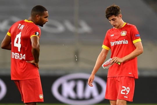 Leverkusens Jonathan Tah (l) und Kai Havertz stehen nach Abpfiff enttäuscht auf dem Platz.