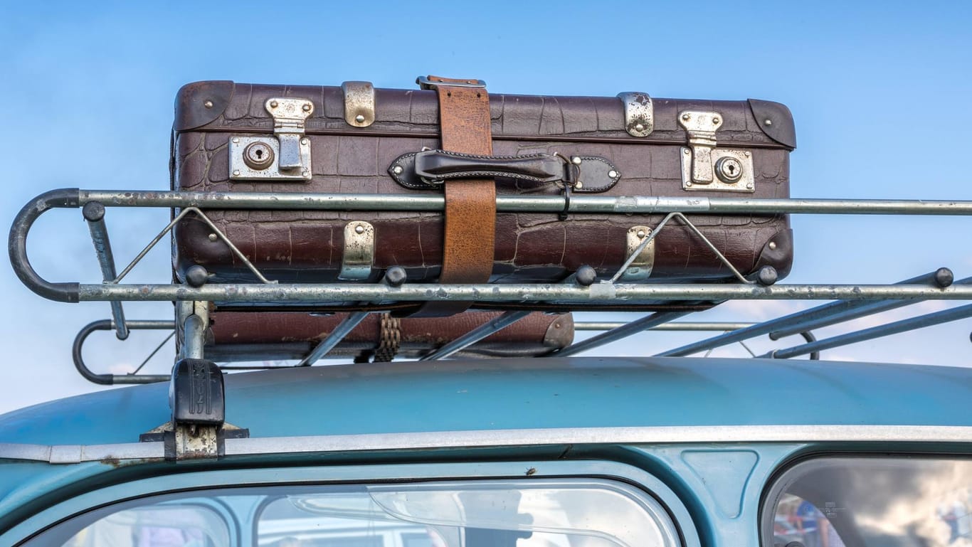 Trabi mit Reisekoffer auf Dachgepäckträger: Hat die Wiedervereinigung Sie dazu bewegt, in ein anderes Land zu ziehen?