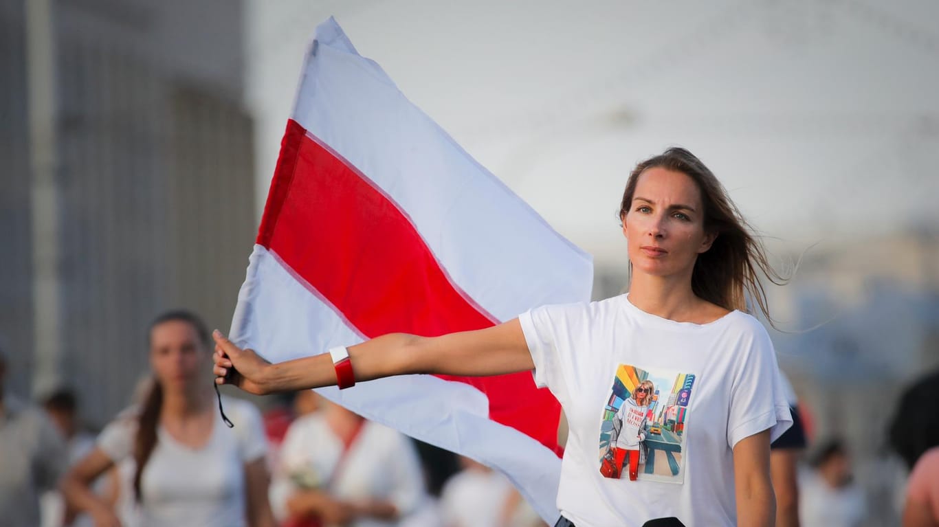 Eine Frau mit der alten belarussischen Flagge: Es sind die Frauen des Landes, die die Protestbewegung ins Rollen gebracht haben.