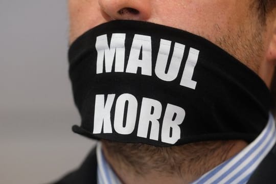 Sven Liebich trägt im Gerichtssaal in Halle einen Mundschutz mit der Aufschrift "Maulkorb".