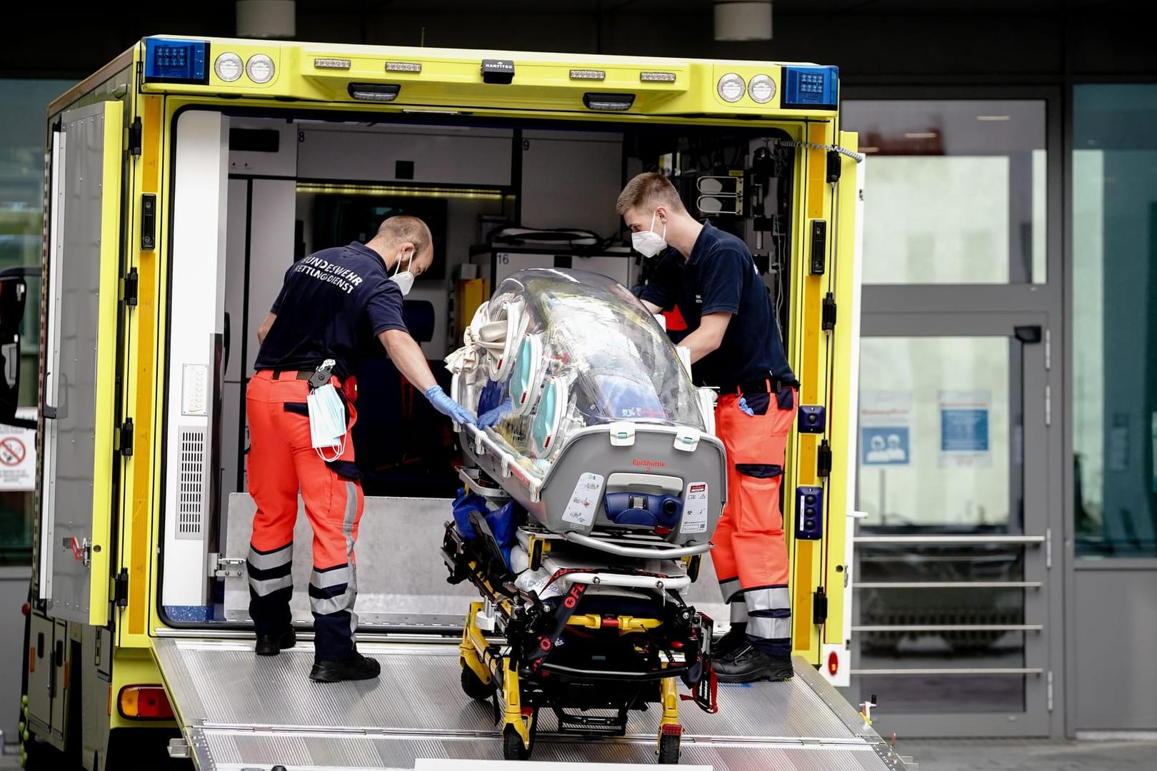 Berlin: Sanitäter vom Bundeswehr Rettungsdienst bringen die Spezialtrage, mit der Nawalny in die Charite eingeliefert wurde, zurück in den Krankenwagen.