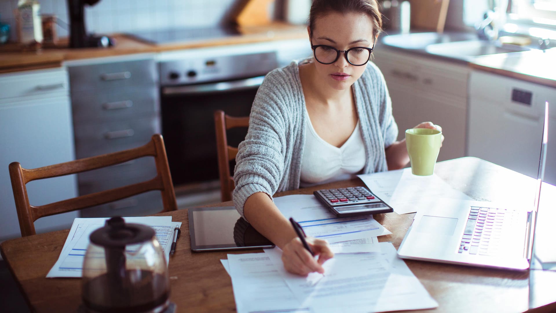 Eine Frau begleicht Rechnungen (Symbolbild): Weil Frauen im Schnitt weniger verdienen als Männer, ist es für sie umso wichtiger, sich mit ihren Finanzen auseinanderzusetzen.