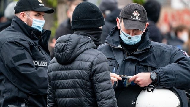 Polizisten kontrollieren die Personalien von einem Teilnehmer einer Demonstration in Hamburg. Polizisten kontrollieren die Personalien von einem Teilnehmer einer Demonstration in Hamburg.