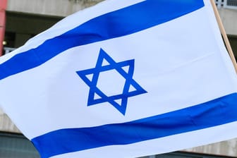 Eine Israel-Flagge weht im Wind (Symbolbild): In Hagen sind gegen einen Mann antisemitische Äußerungen gefallen, weil er eine solche Flagge hochgehalten hatte.