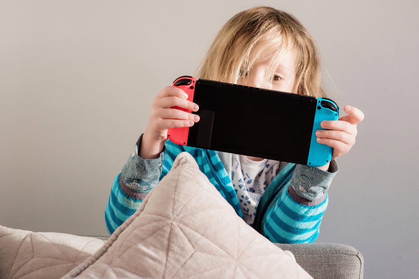 Ein Mädchen spielt mit einer Switch-Konsole (Symbolbild): Nintendo soll Herbst den Verkaufsstart einer neuen Version der beliebten Nintendo Switch planen.