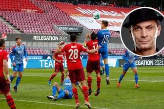 Der entscheidende Moment im ersten Relegationsspiel: Kiels Simon Lorenz setzt sich gegen den FC-Kapitän Jonas Hector im Kopfballduell durch – und macht das 1:0.