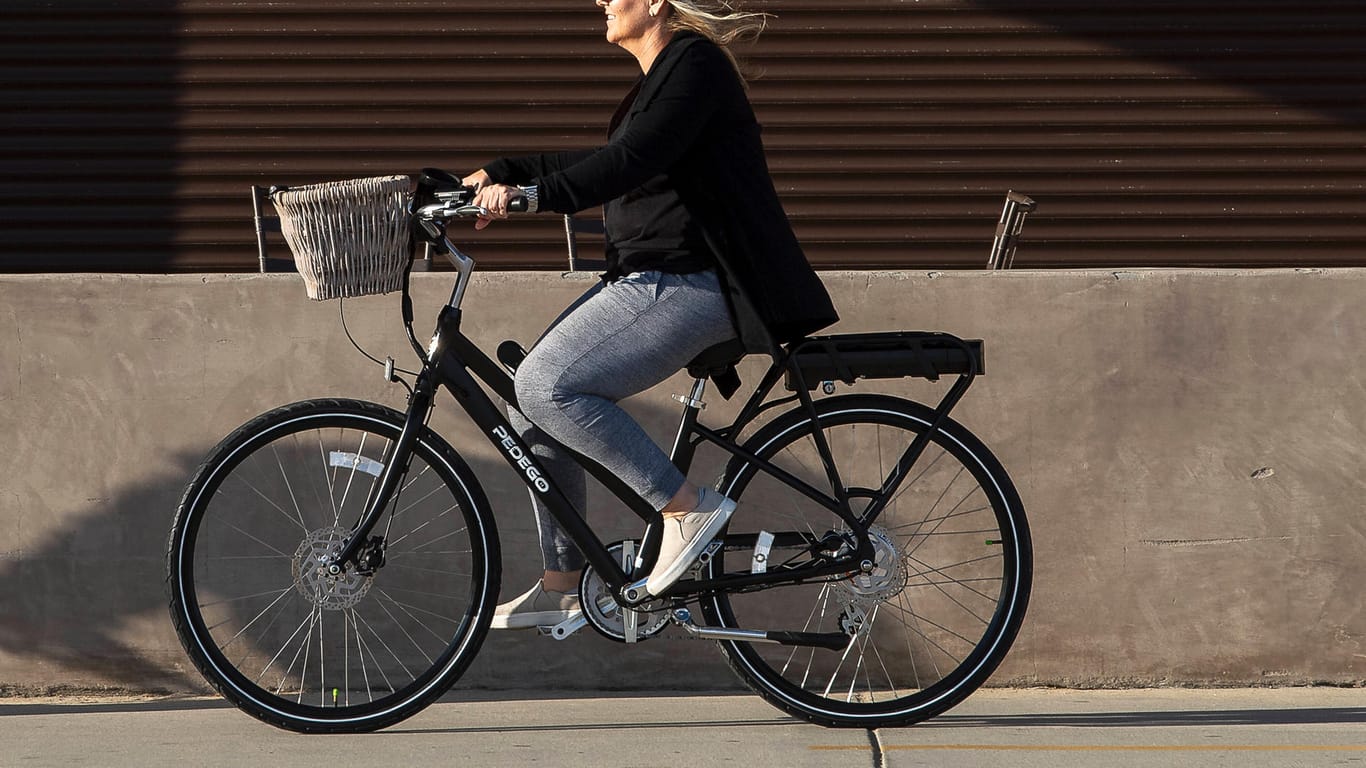 Eine Frau fährt mit einem E-Bike (Symbolbild): In Hamburg steht eine neue E-Bike-Flotte für Kurzzeitmieten zur Verfügung.