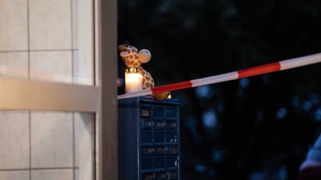 Ein Teddybär und eine Kerze vor dem Wohnhaus in Solingen.