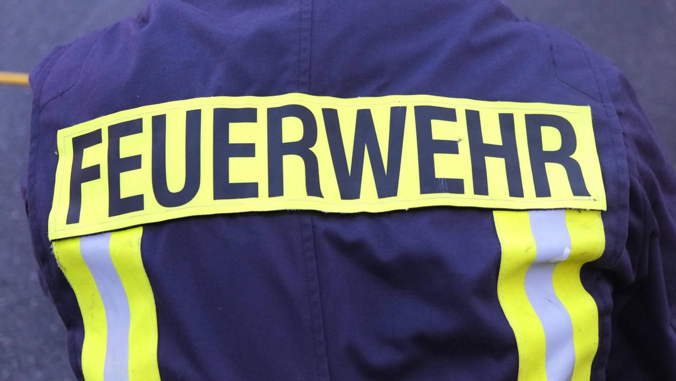 Der Rücken einer Person mit Feuerwehr-Uniform: In Düsseldorf wurde ein Mitglied der Feuerwehr wegen Mobbing-Vorwürfen vom Dienst freigestellt.