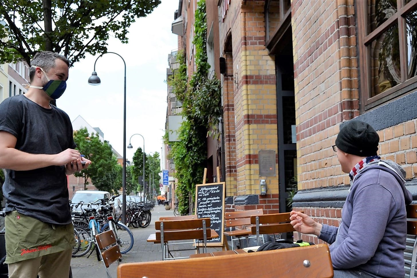 Im Brauhaus Schäfer bedient ein Kellner einen Gast: Noch können die Gäste draußen sitzen, doch wie es im Winter aussieht, das wissen die Kölner Gastronomen noch nicht.