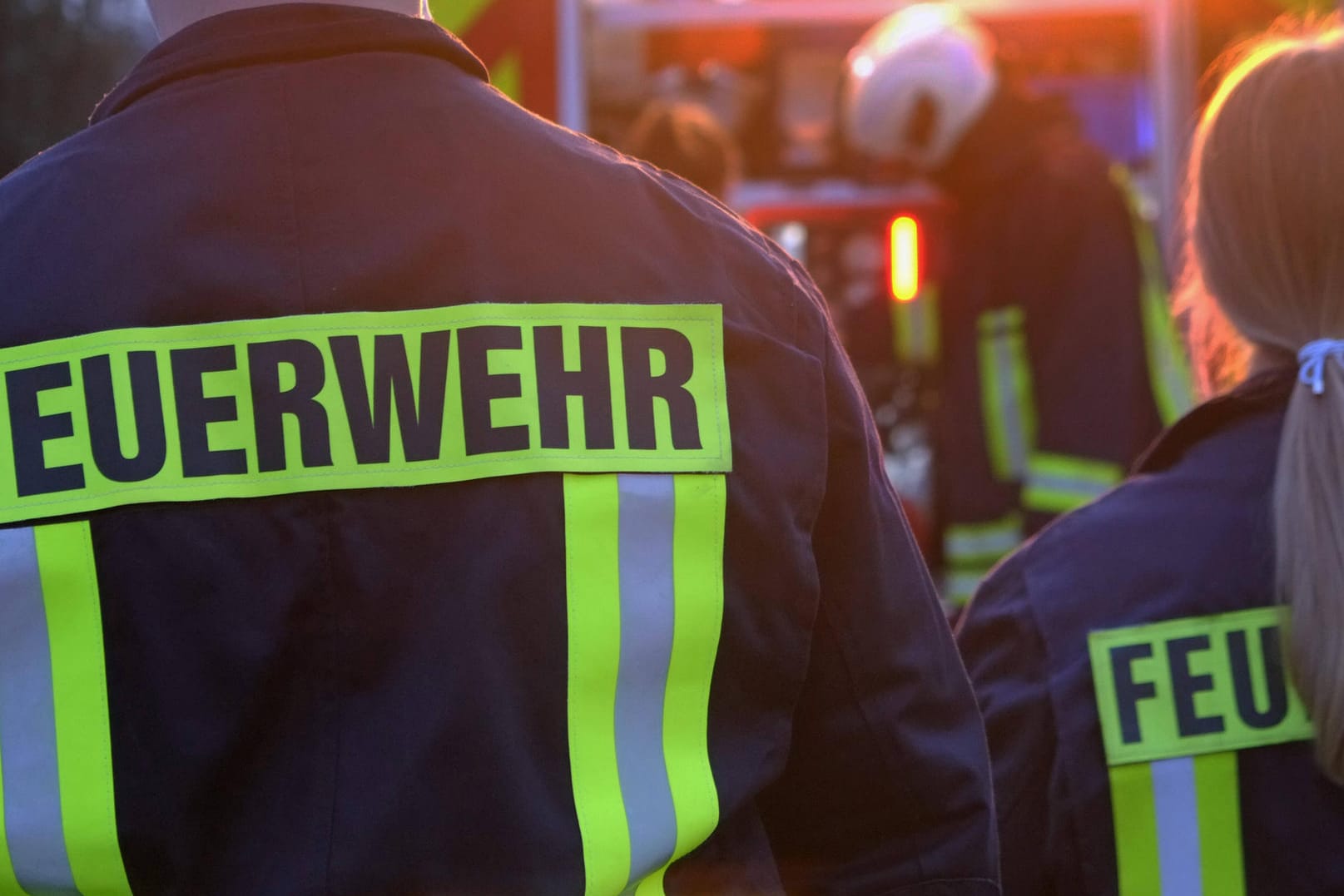 Feuerwehrleute stehen vor einem Einsatzwagen (Symbolbild): Ein Mann ist bei einem Brand in einer Erfurter Wohnung ums Leben gekommen.