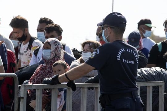 Migranten vor dem Eingang des Lagers Kara Tepe Schlange.