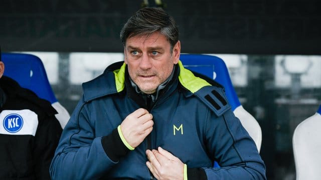 Der Karlsruher Sportdirektor Oliver Kreuzer sitzt während eines Spiels auf der Bank. Der Karlsruher Sportdirektor Oliver Kreuzer sitzt während eines Spiels auf der Bank.