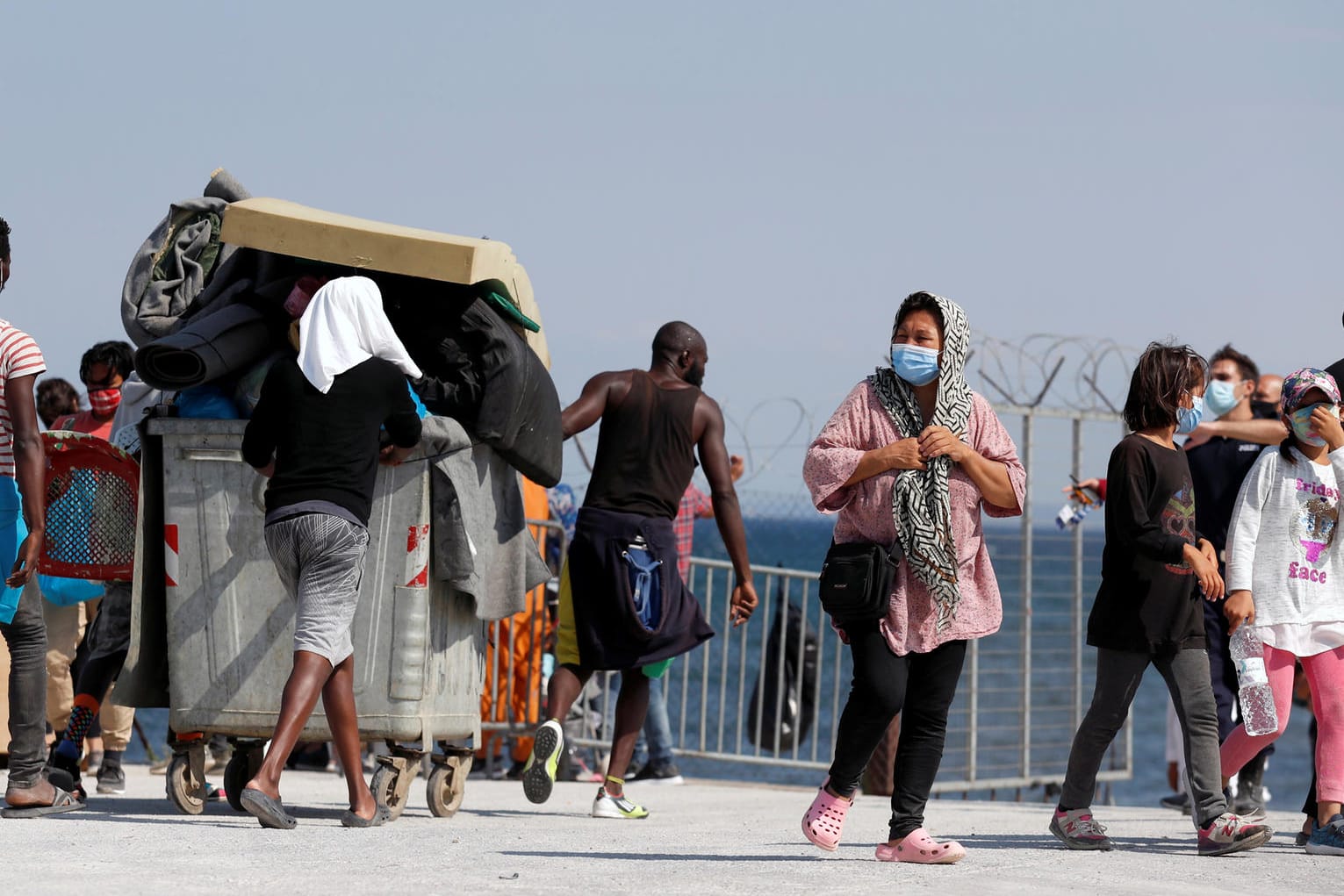 Migranten vor dem neuen provisorischen Lager: Die Behörden haben sechs mutmaßliche Brandstifter in Untersuchungshaft genommen.