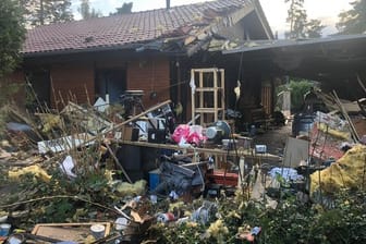 Trümmer liegen vor dem schuppenartigen Anbau: Der 49-Jährige kam mit Verbrennungen in eine Klinik.