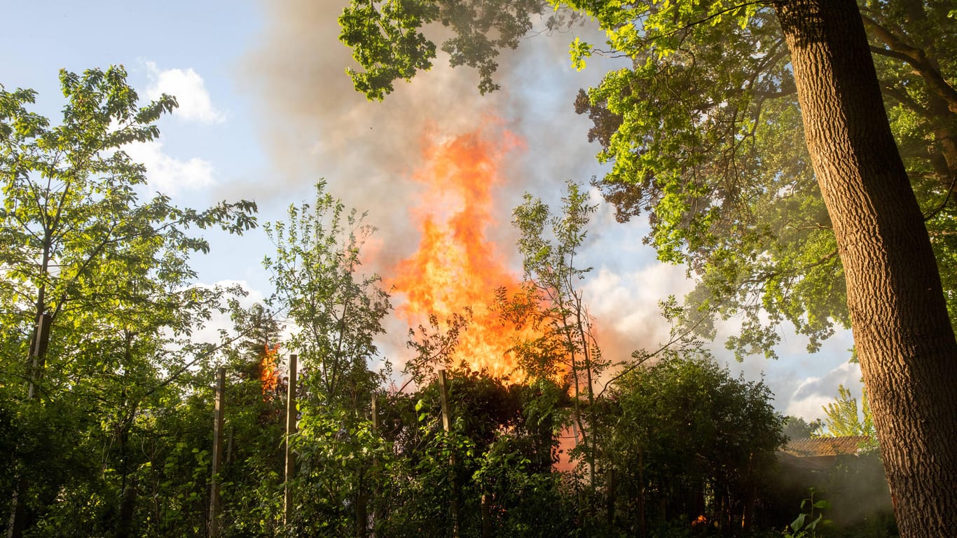 Eine Gartenlaube steht in Flammen (Symbolbild): In Hagen-Hohenlimburg ist eine Gartenlaube komplett ausgebrannt.