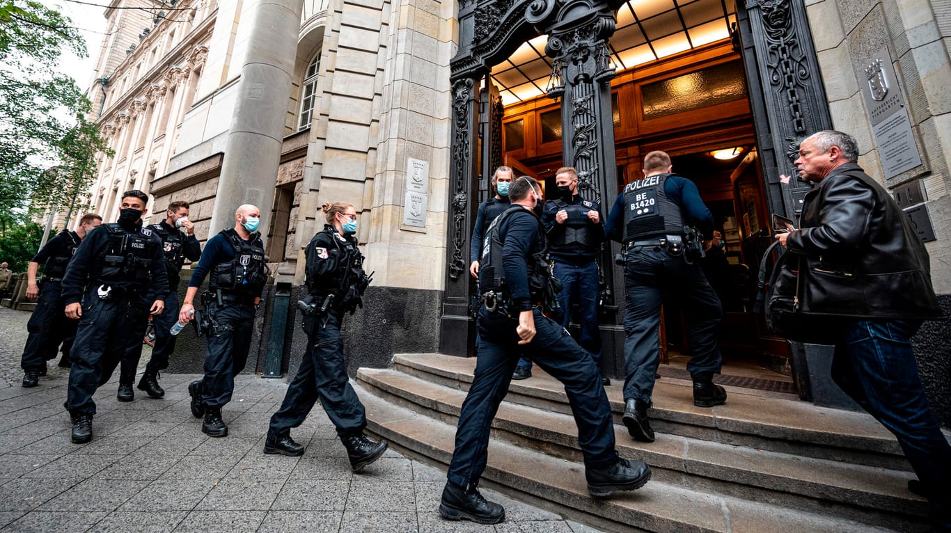 Polizisten betreten vor Prozessbeginn das Kriminalgericht Berlin-Moabit.