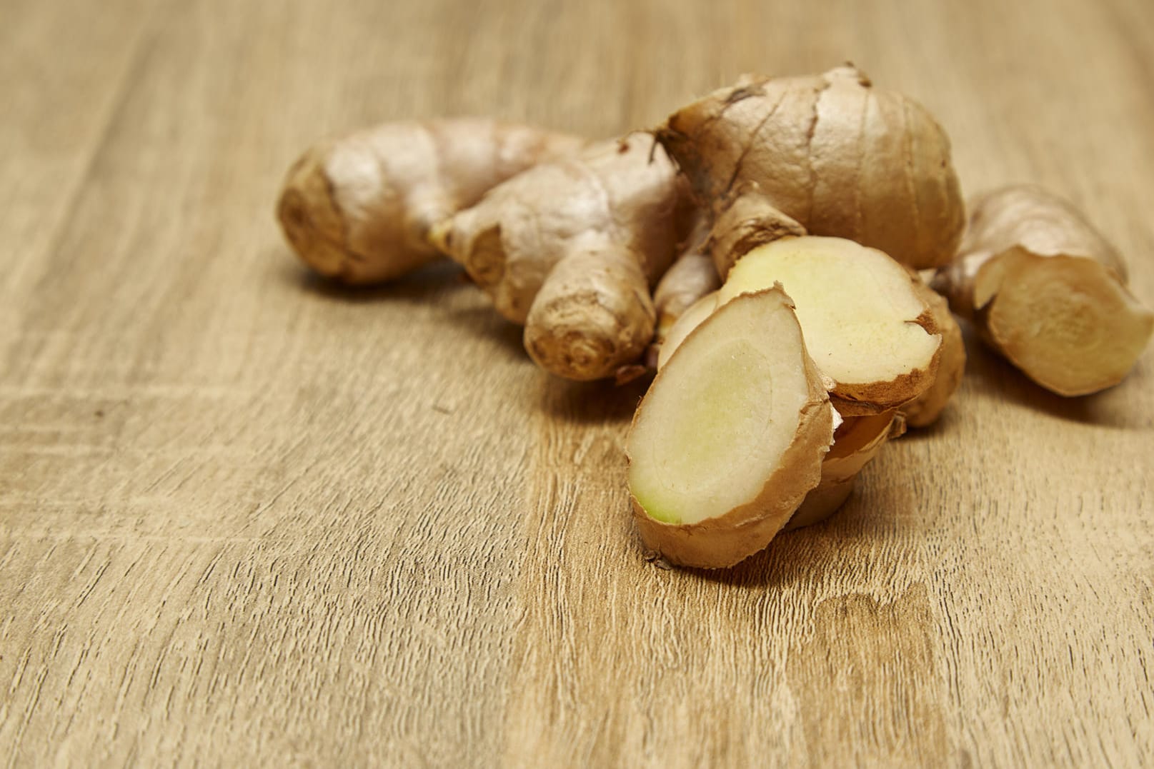 Raw Ginger root sliced on rustic wooden table background (Kumruen)