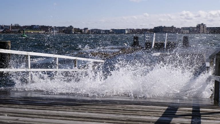 Wasser spritzt an einem Steg in Kiel (Symbolbild): Am Mittwoch wird Hochwasser an der Ostsee erwartet.