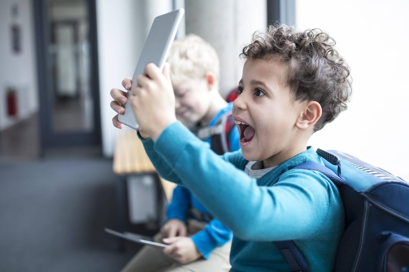 Endlich da: Ein Schüler ist glücklich über ein neues Tablet.