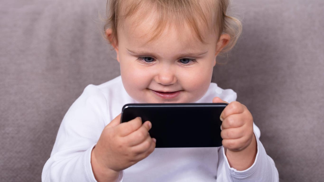 Aus Versehen verschickt: Ein kleines Kind mit einem Handy (Symbolbild).