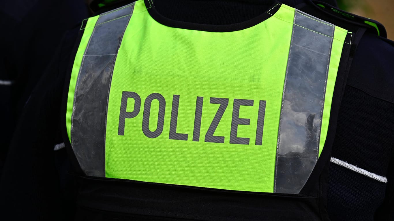 Ein Polizist trägt eine Warnweste mit dem Schriftzug "Polizei" (Symbolbild): In Köln hat ein Mann einen Polizisten mit Reizgas angegriffen.
