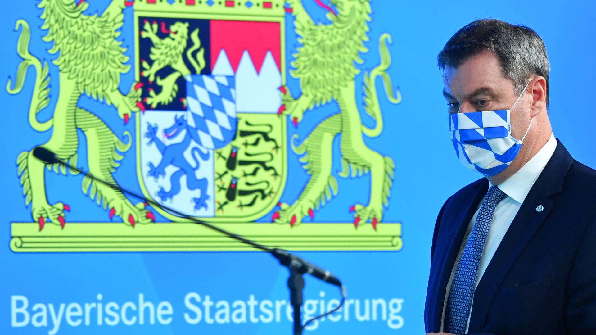 Bayerns Ministerpräsident Söder mit Mundschutz vor bayerischem Wappen: Söder kündigt eine neue Warnstufe an. Bayerns Ministerpräsident Söder mit Mundschutz vor bayerischem Wappen: Söder kündigt eine neue Warnstufe an.