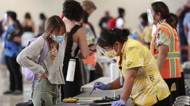 Eine Reisende auf Hawaii lässt sich vor einem Test beraten.