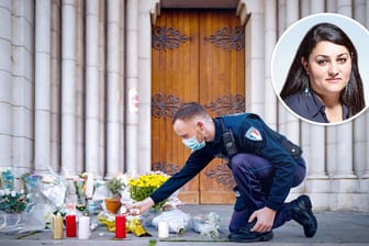 Ein Polizist zündet vor der Kathedrale in Nizza eine Kerze an: Hier wurden drei Menschen von einem mutmaßlichen Islamisten ermordet.