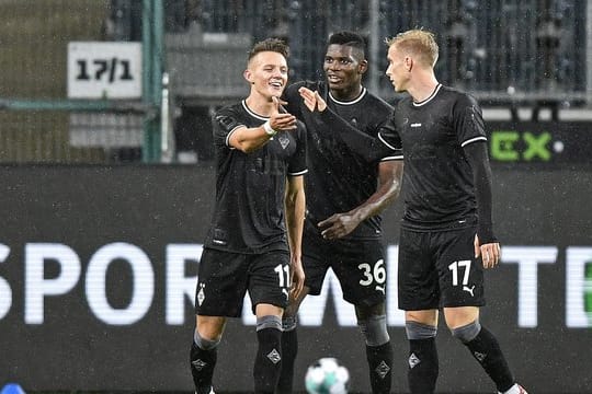 Gladbachs Hannes Wolf (l) bejubelt seinen Treffer mit Breel Embolo (M) und Oscar Wendt (r).