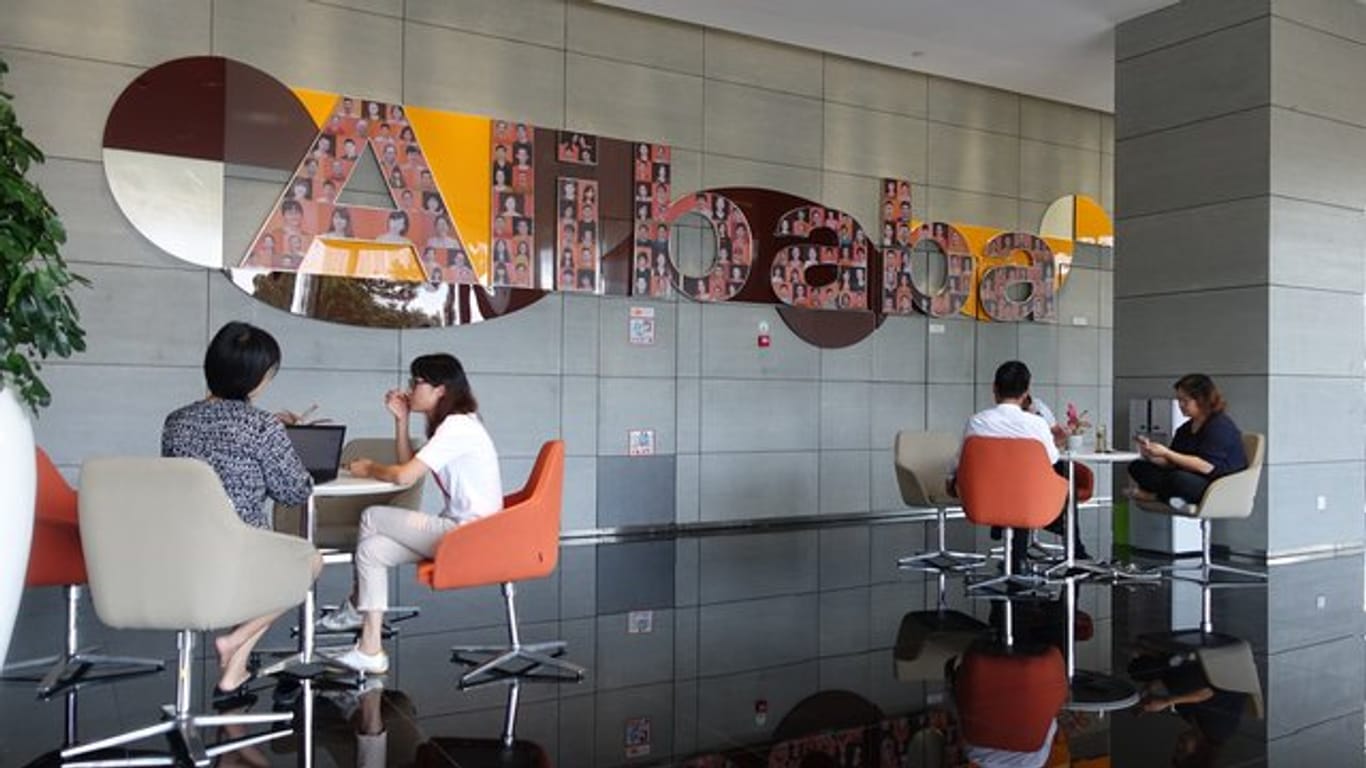 Mitarbeiter sitzen in einem Foyer der Firmenzentrale von Alibaba in Hangzhou.