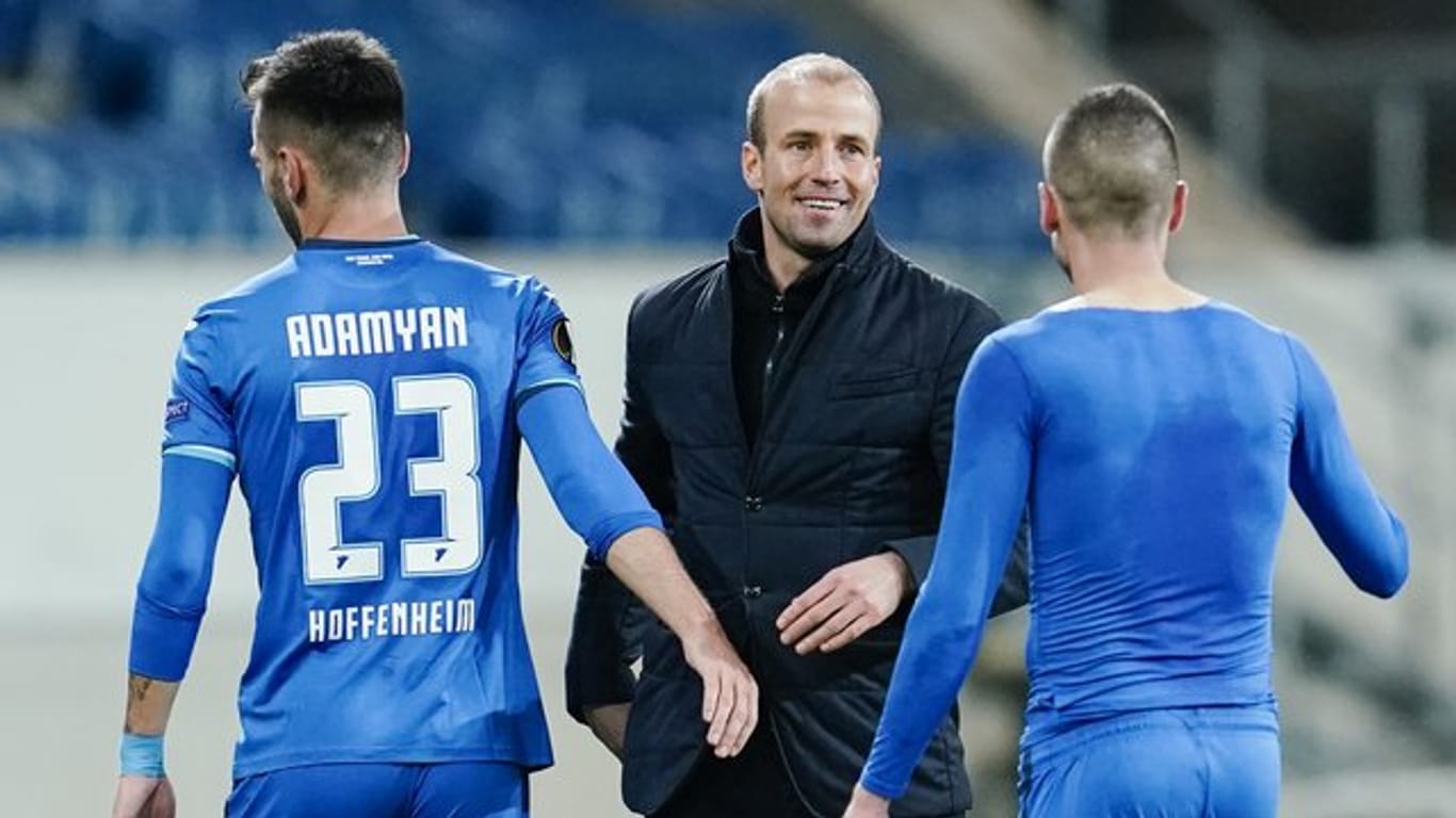 Hoffenheims Trainer Sebastian Hoeneß (M) freut sich nach Spielende mit Sargis Adamyan (l) und Mijat Gacinovic über den Sieg.