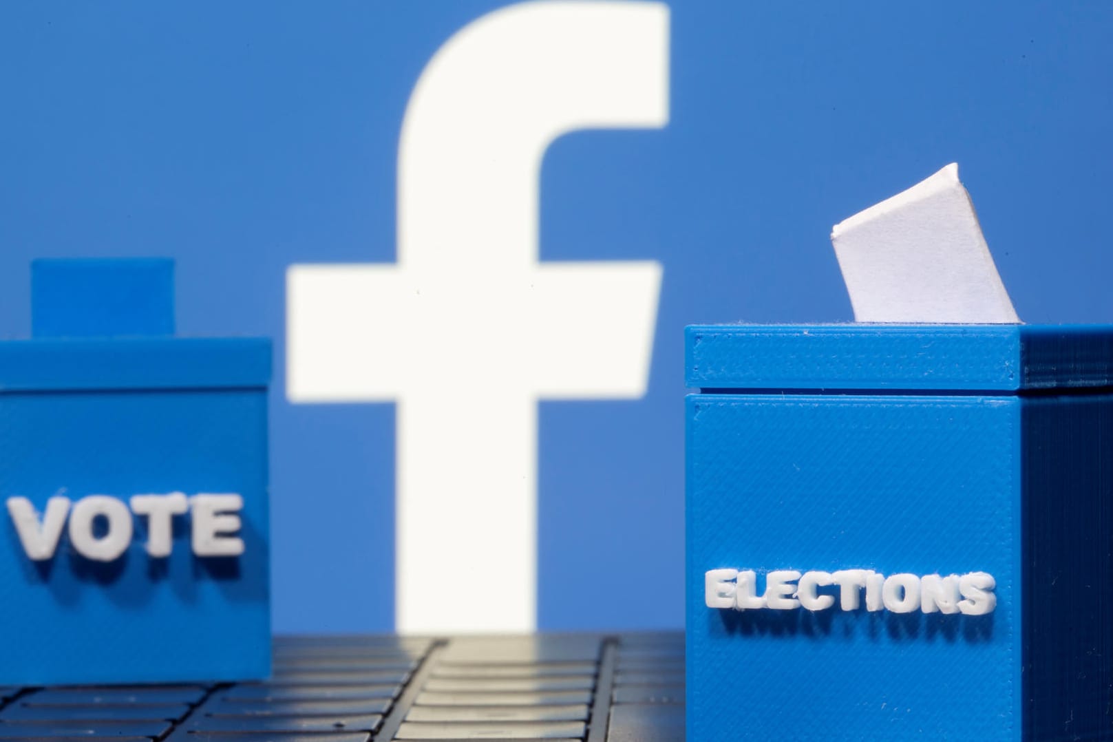 Facebook-Logo und Wahlurnen: Vor, während und nach der US-Wahl kämpft das soziale Netzwerk gegen Falschmeldungen und Gewaltaufrufe an.