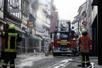 Einsatzkräfte der Feuerwehr stehen in der historischen Altstadt: In Hann. Münden im Landkreis Göttingen ist am Freitagabend in einem Geschäftshaus ein Feuer ausgebrochen.