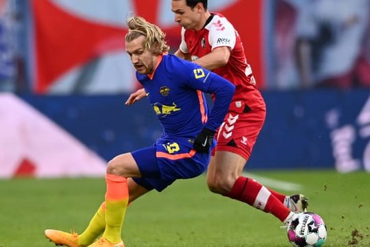 Leipzigs Emil Forsberg (l) und Freiburgs Nicolas Höfler kämpfen um den Ball.